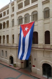 Two-story tall Cuban flag hanging on the side of a building