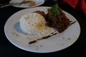 A pile of white rice and shredded beef on a white plate