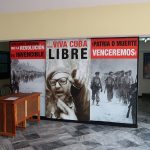 Sign with images of Fidel Castro and soldiers, along with patriotic slogans