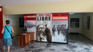 Sign with images of Fidel Castro and soldiers, along with patriotic slogans